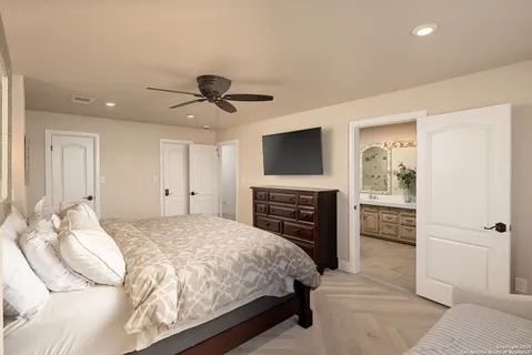 a bedroom with a bed and a television