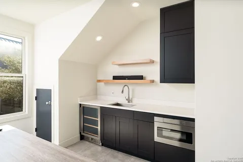 a kitchen with a sink and a refrigerator