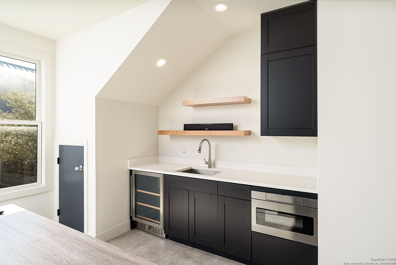 1240 Rip Jay Circle Canyon Lake, TX 78133 - Photo 31 of 52 a kitchen with a sink and a refrigerator