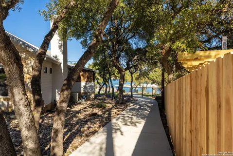 a view of a backyard with wooden fence