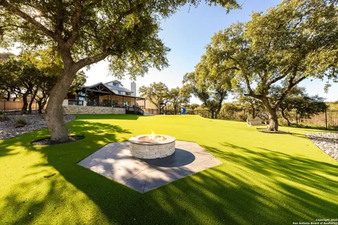 a view of a swimming pool with yard and tree s