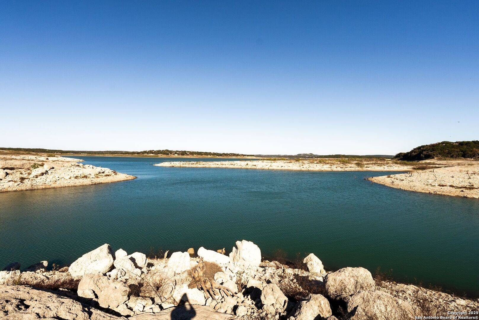 1240 Rip Jay Circle Canyon Lake, TX 78133 - Photo 43 of 52 a view of a lake with a mountain in the background