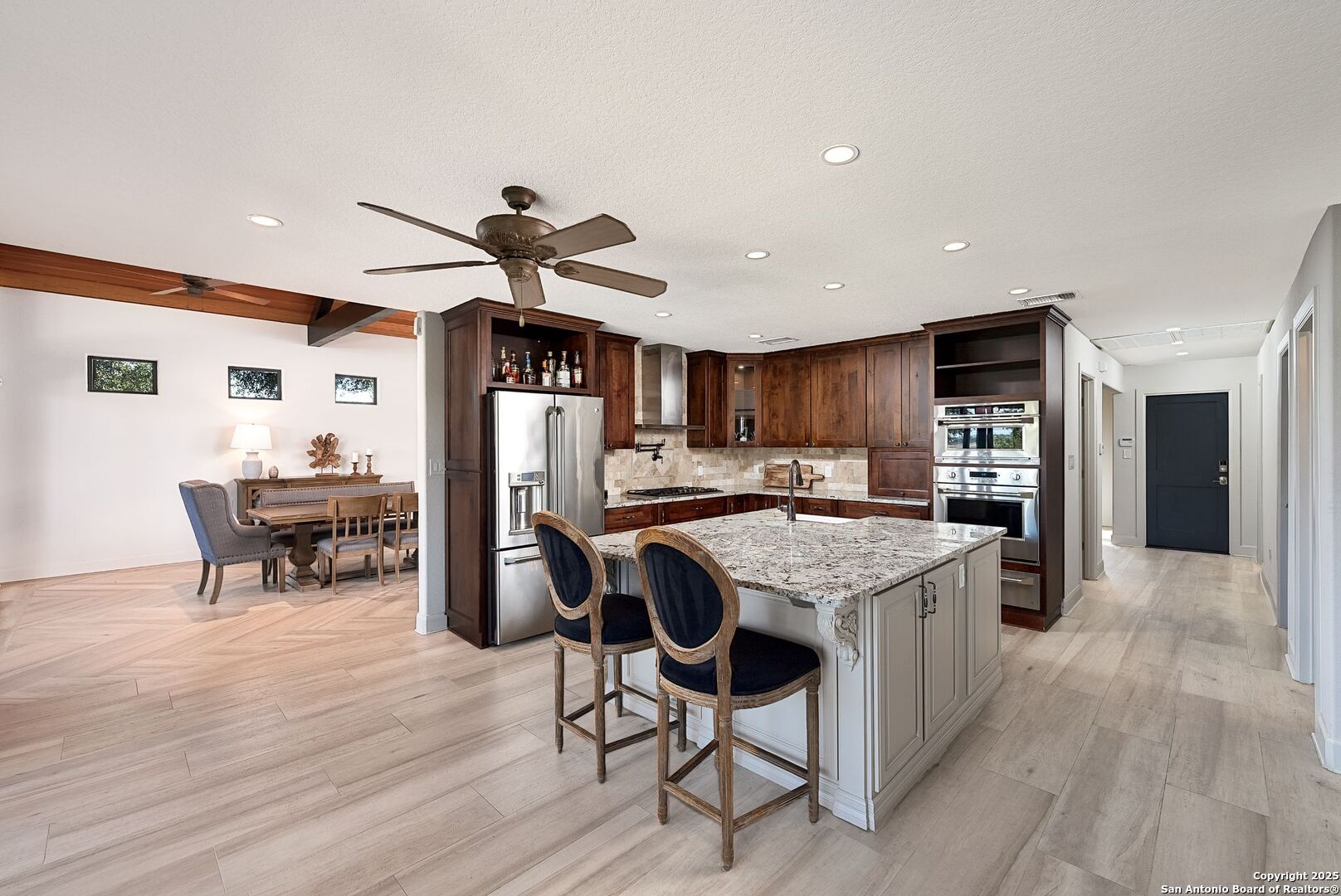 1240 Rip Jay Circle Canyon Lake, TX 78133 - Photo 10 of 52 a open kitchen with stainless steel appliances granite countertop a table chairs a refrigerator and a sink