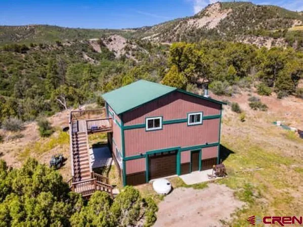 an aerial view of a house with a yard