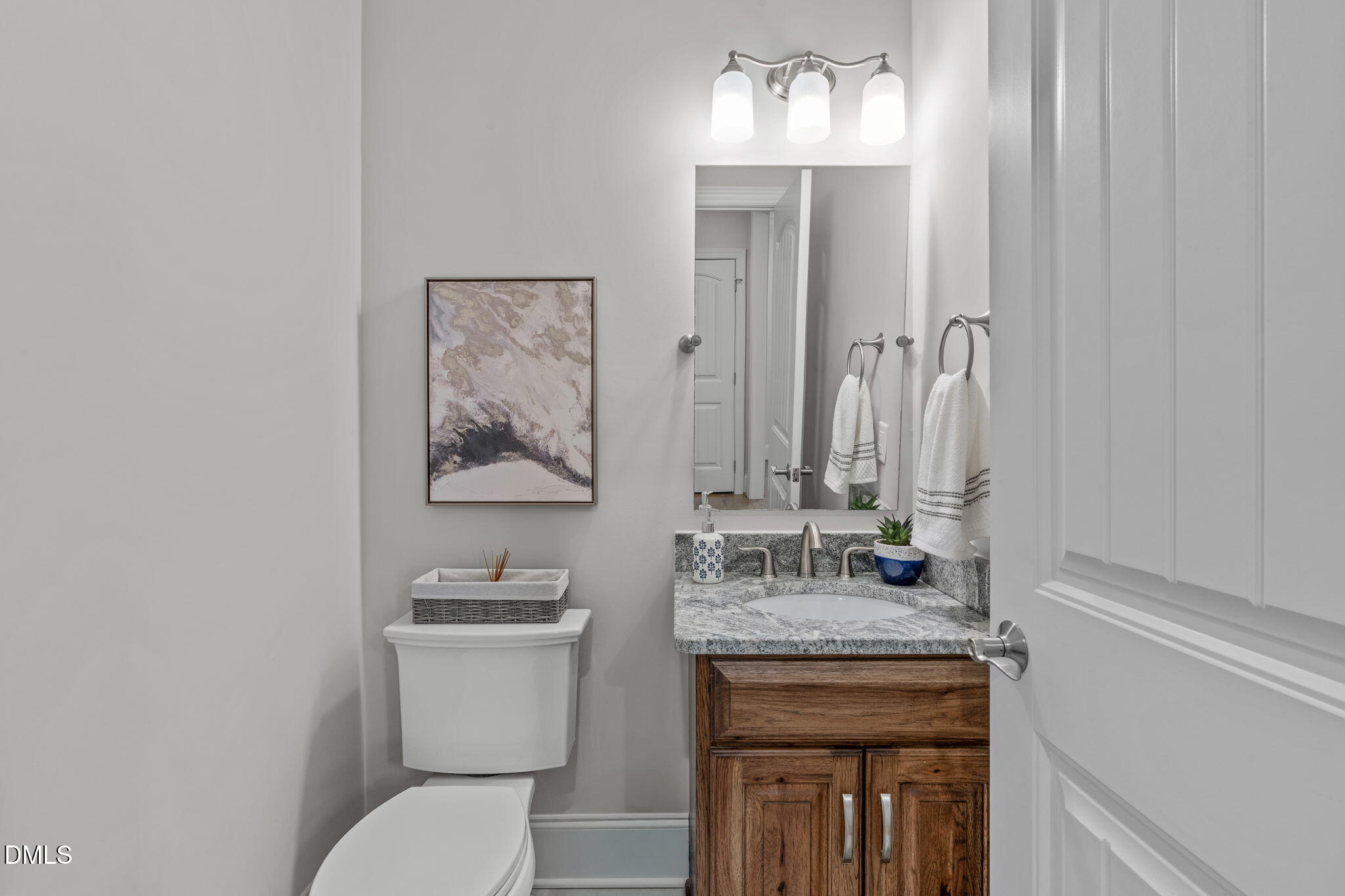 261 Character Drive Rolesville, NC 27571 - Photo 17 of 61 a bathroom with a granite countertop sink a toilet and a mirror