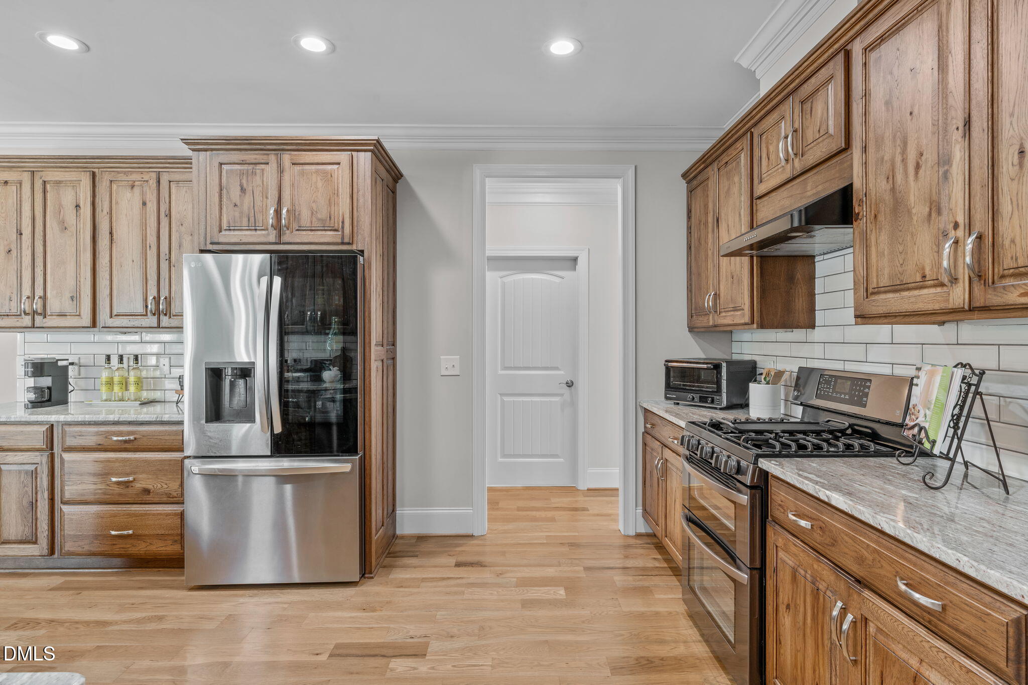 261 Character Drive Rolesville, NC 27571 - Photo 18 of 61 a kitchen with stainless steel appliances granite countertop a refrigerator a stove and a sink