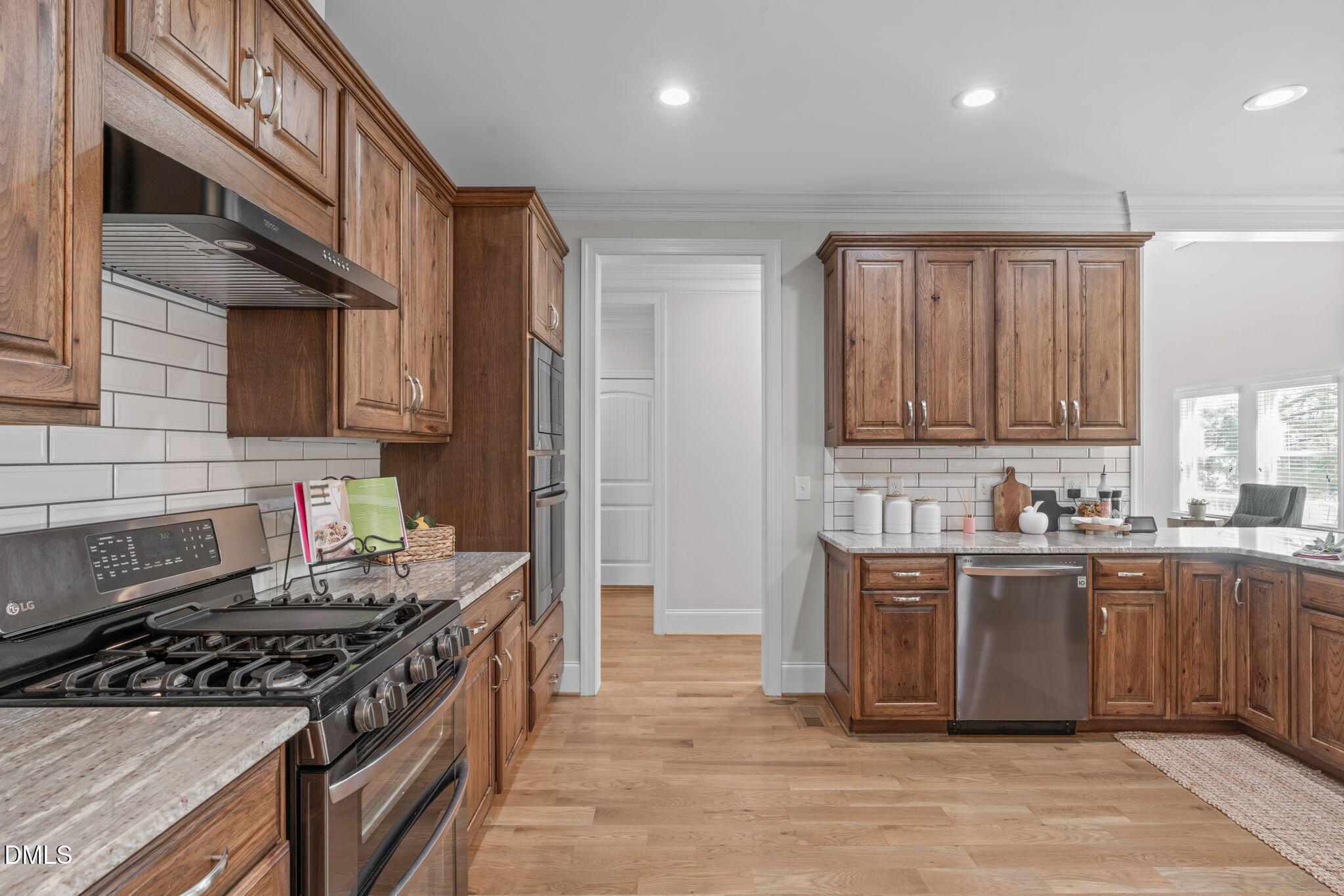 261 Character Drive Rolesville, NC 27571 - Photo 20 of 61 a kitchen with stainless steel appliances granite countertop a stove a sink dishwasher and a refrigerator