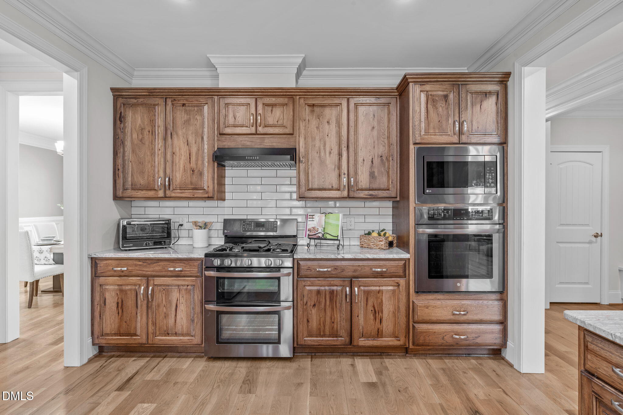 261 Character Drive Rolesville, NC 27571 - Photo 21 of 61 a kitchen with stainless steel appliances granite countertop a stove and cabinets