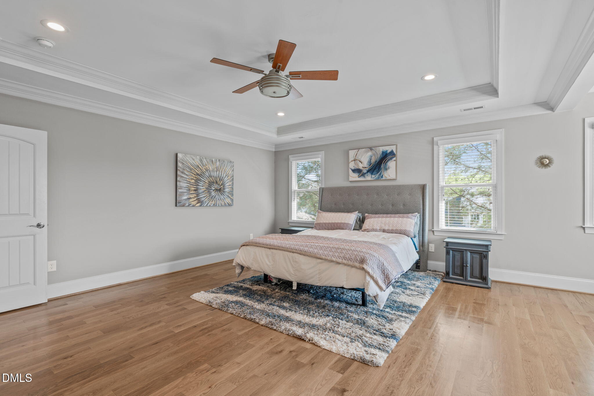 261 Character Drive Rolesville, NC 27571 - Photo 32 of 61 a spacious bedroom with a bed and a painting on the wall