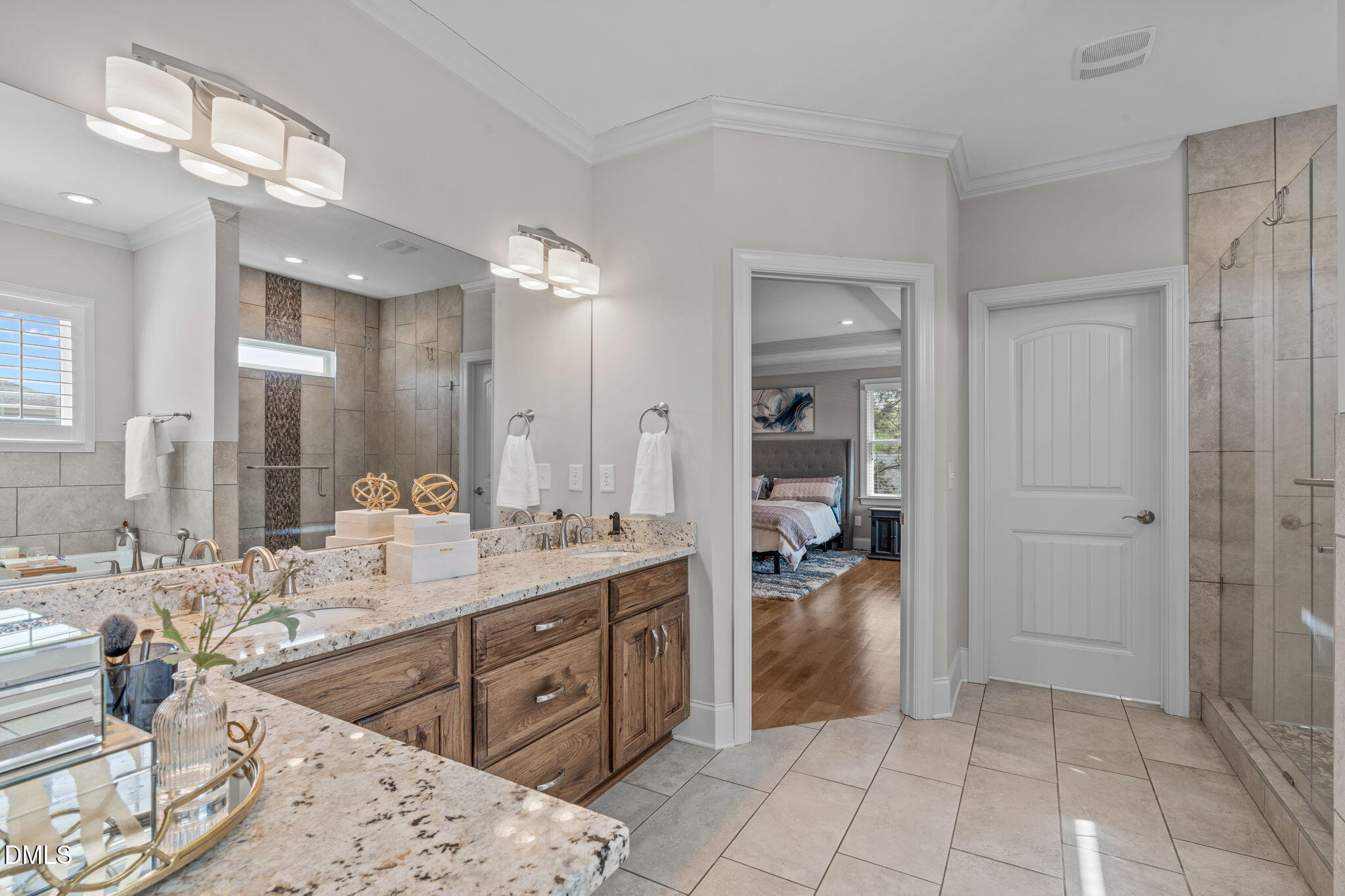 261 Character Drive Rolesville, NC 27571 - Photo 35 of 61 a spacious bathroom with a mirror sink and shower