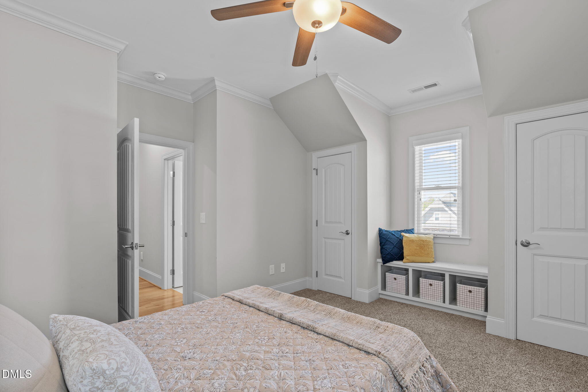 261 Character Drive Rolesville, NC 27571 - Photo 41 of 61 a bedroom with a bed and a chandelier