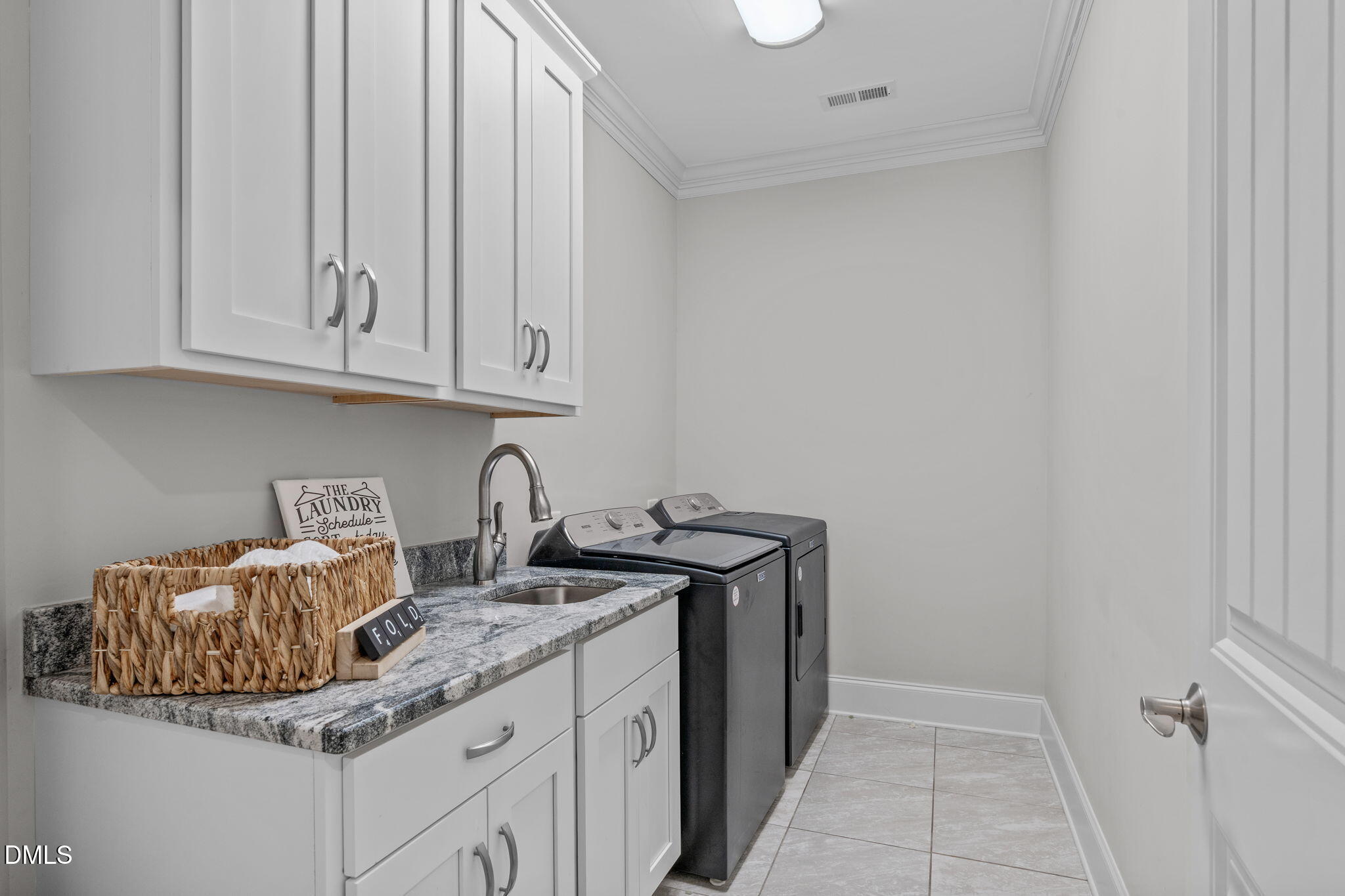 261 Character Drive Rolesville, NC 27571 - Photo 48 of 61 a kitchen with granite countertop a sink and cabinets