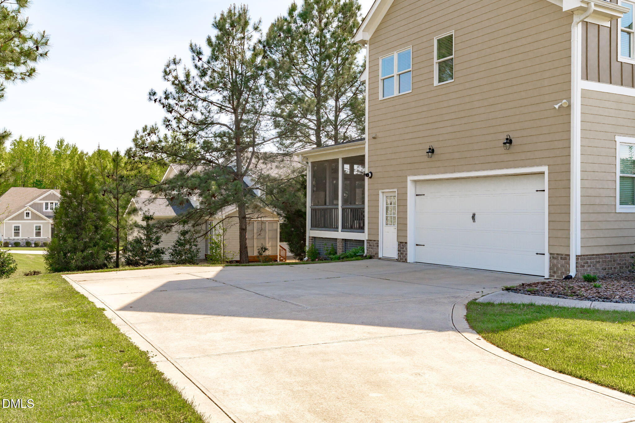 261 Character Drive Rolesville, NC 27571 - Photo 60 of 61 a view of a white house with a yard and large tree