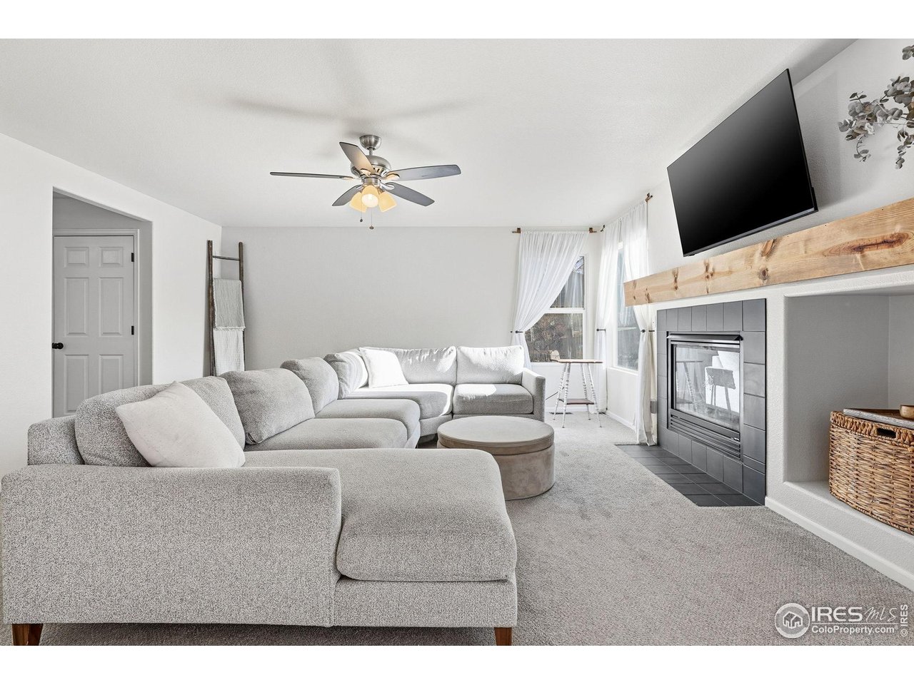 1273 Trail Ridge Road Longmont, CO 80504 - Photo 5 of 44 The spacious and cozy living room with gas fireplace and farmhouse style mantle is the perfect place to entertain friends or wind down after a long day.