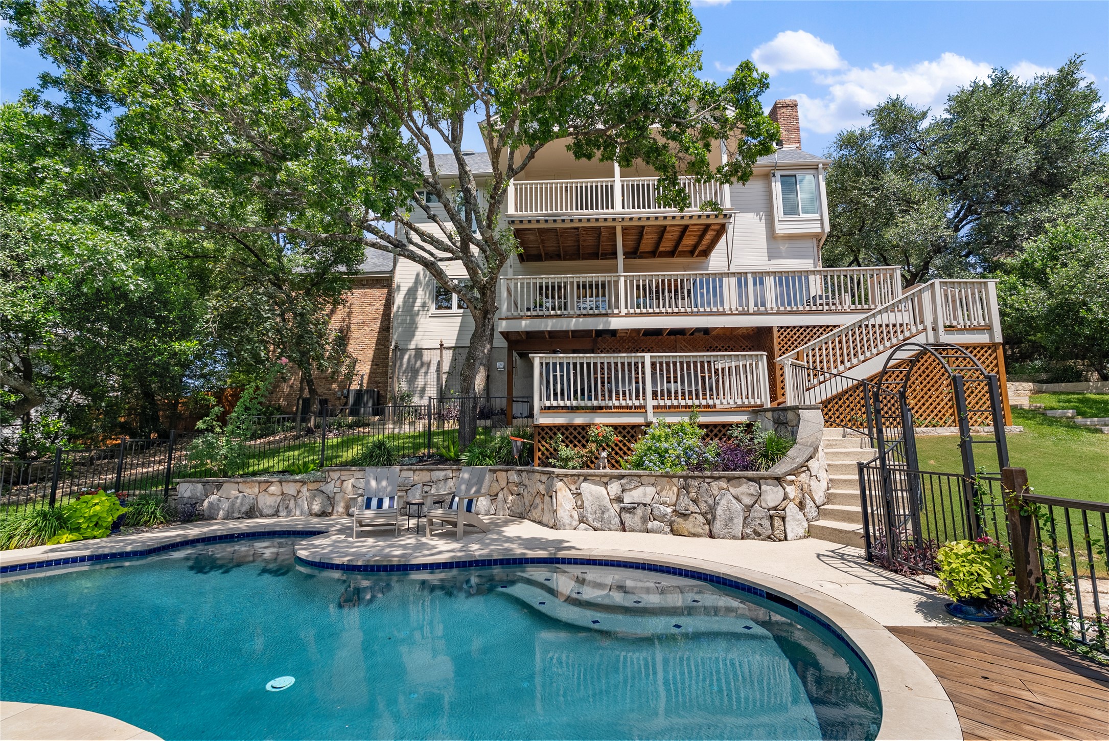 3107 Lookout Lane Austin, TX 78746 - Photo 35 of 39 Terraced decks and a refreshing pool define the backyard oasis of this elegant home.