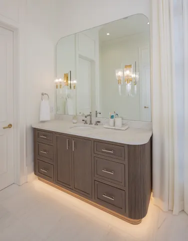 a bathroom with a sink vanity and mirror