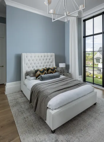 a bedroom with a bed and large window