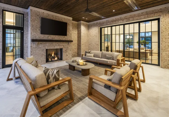a living room with furniture a flat screen tv and a fireplace