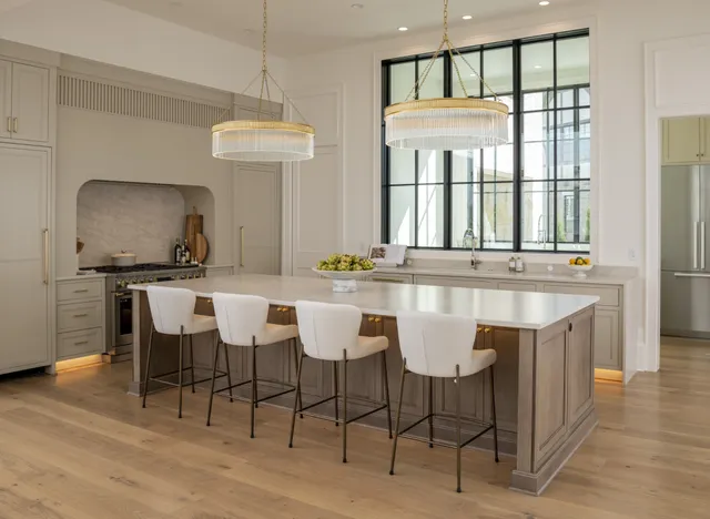 a dining room with furniture a chandelier and wooden floor