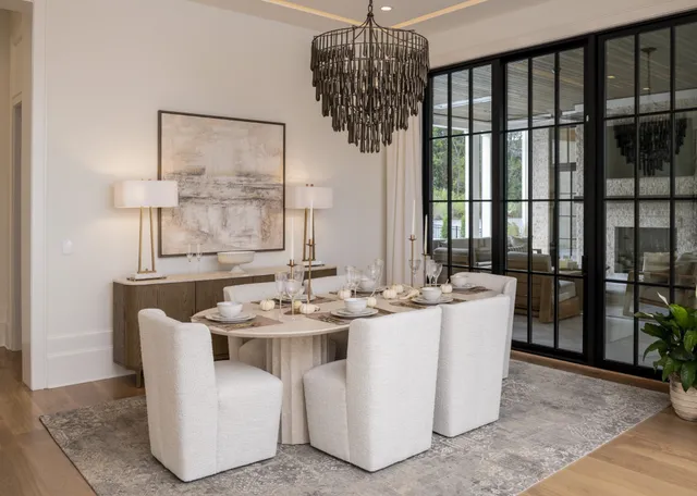a dining room with furniture a chandelier and wooden floor