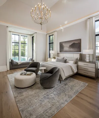 a living room with furniture a chandelier and a flat screen tv