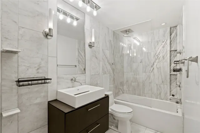 a bathroom with a sink toilet tub and shower