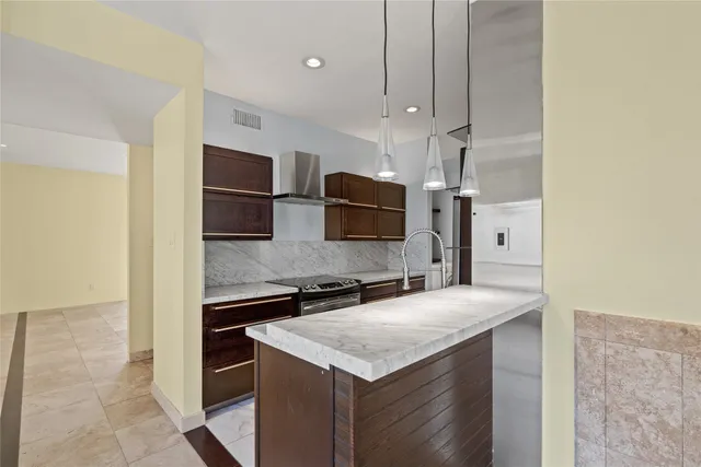 a kitchen with stainless steel appliances a sink and a refrigerator
