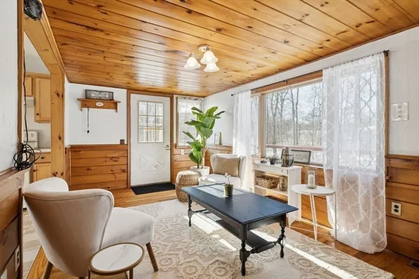 a living room with furniture a fireplace and a table