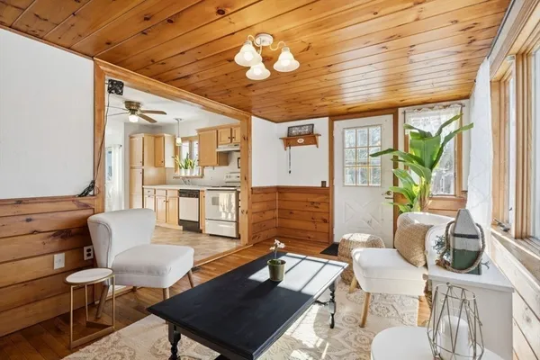 a living room with furniture a wooden floor and a chandelier