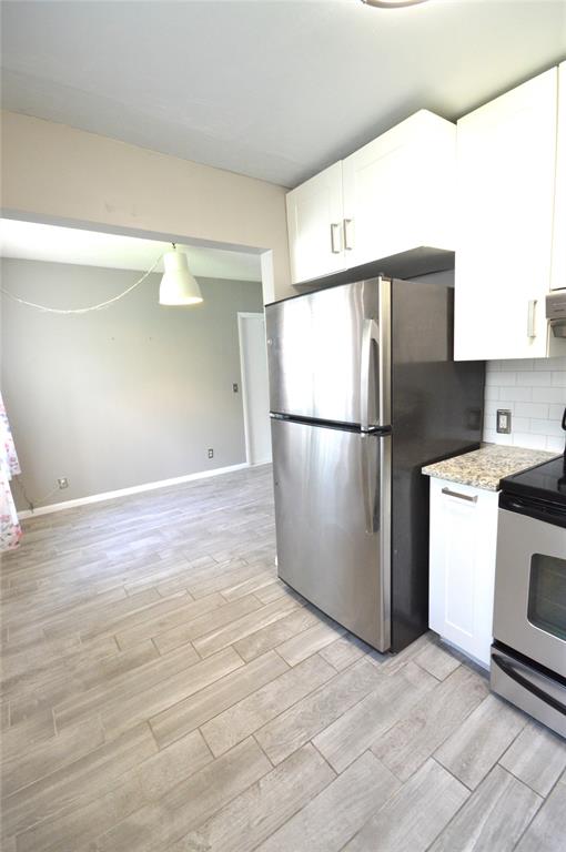 144 Mansfield D, Unit 144 Boca Raton, FL 33434 - Photo 11 of 37 a kitchen with a refrigerator and a stove