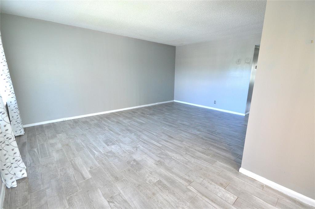 144 Mansfield D, Unit 144 Boca Raton, FL 33434 - Photo 13 of 37 an empty room with wooden floor