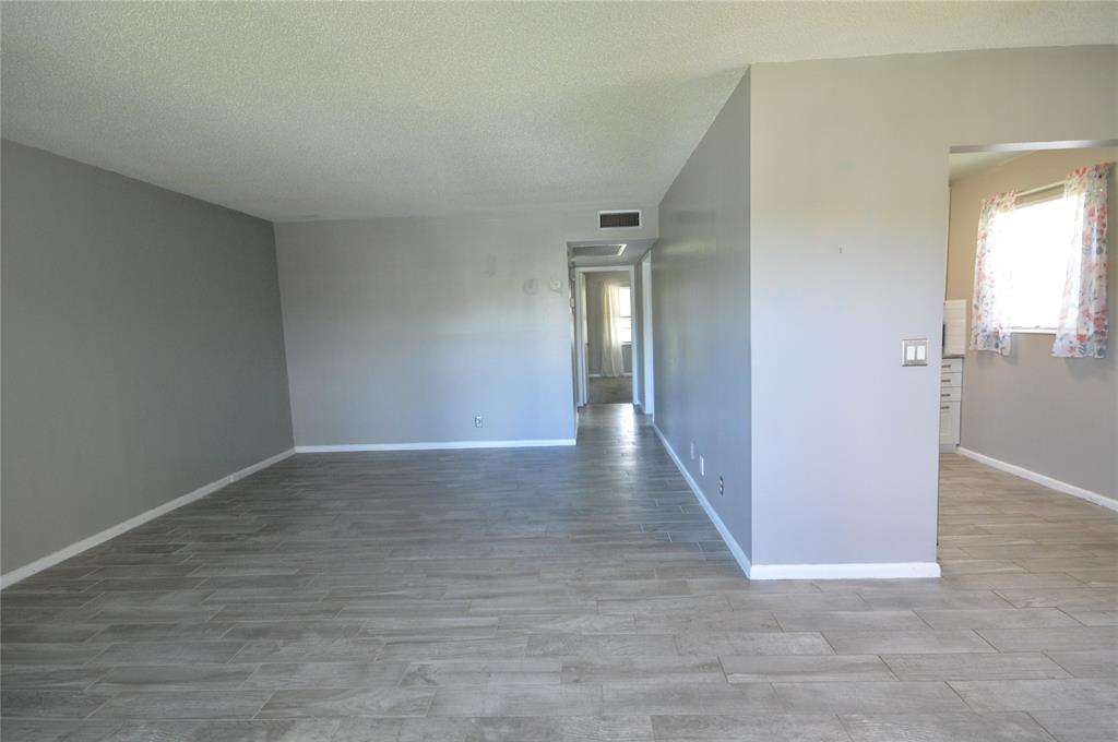 144 Mansfield D, Unit 144 Boca Raton, FL 33434 - Photo 15 of 37 a view of a hallway with wooden floor