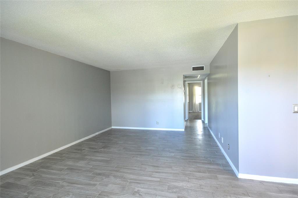 144 Mansfield D, Unit 144 Boca Raton, FL 33434 - Photo 16 of 37 a view of hallway with wooden floor