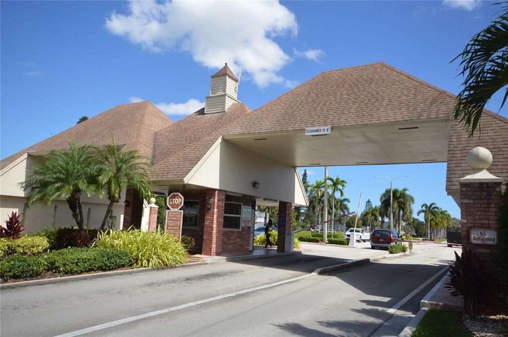 144 Mansfield D, Unit 144 Boca Raton, FL 33434 - Photo 2 of 37 a view of a building with potted plants