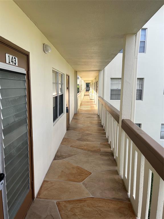 144 Mansfield D, Unit 144 Boca Raton, FL 33434 - Photo 28 of 37 a view of a hallway with wooden floor and staircase