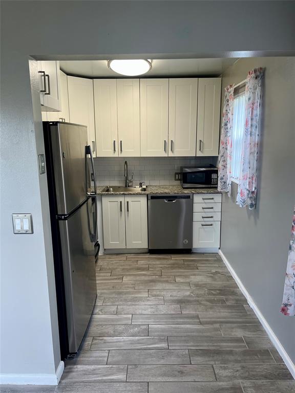 144 Mansfield D, Unit 144 Boca Raton, FL 33434 - Photo 29 of 37 a kitchen with stainless steel appliances a refrigerator sink and cabinets