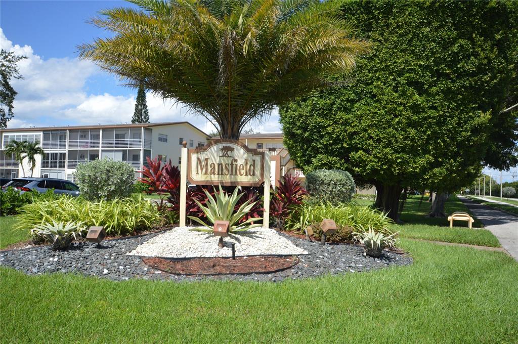 144 Mansfield D, Unit 144 Boca Raton, FL 33434 - Photo 3 of 37 a front view of a house with a yard