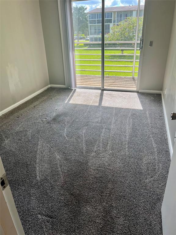 144 Mansfield D, Unit 144 Boca Raton, FL 33434 - Photo 34 of 37 a view of an empty room with a window