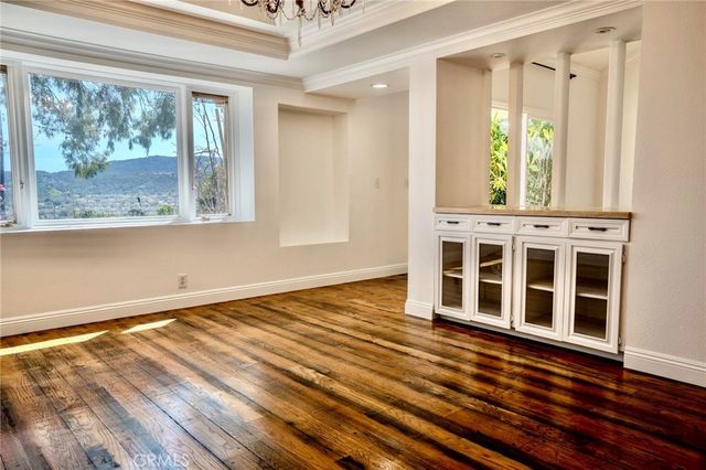 a view of a room with wooden floor and door