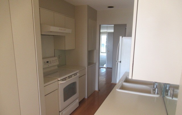 701 Forum Square, Unit 607 Glenview, IL 60025 - Photo 8 of 13 a kitchen with white cabinets and a sink