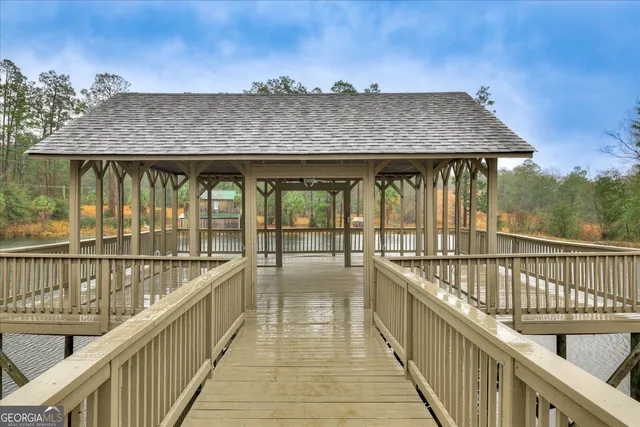 a view of balcony with wooden floor and fence