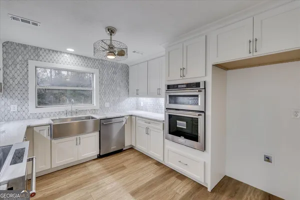 a kitchen with stainless steel appliances granite countertop a stove and a refrigerator