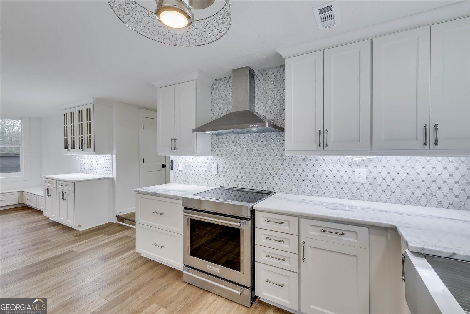4756 Mike Padgett Highway Augusta, GA 30906 - Photo 14 of 28 a kitchen with cabinets appliances and a wooden floor