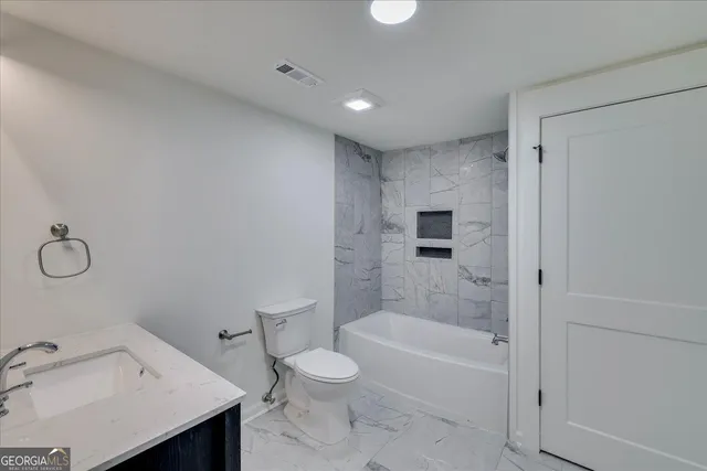 a bathroom with a bathtub toilet and sink