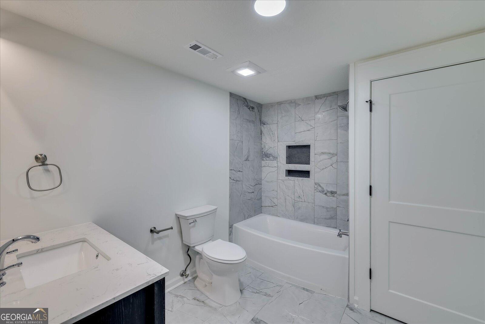 4756 Mike Padgett Highway Augusta, GA 30906 - Photo 19 of 28 a bathroom with a bathtub toilet and sink