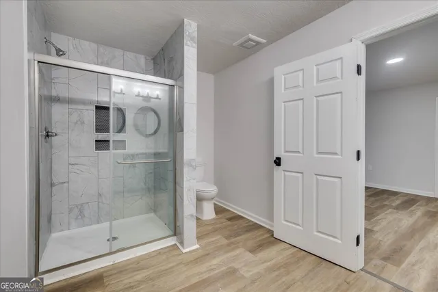 a bathroom with a glass shower door