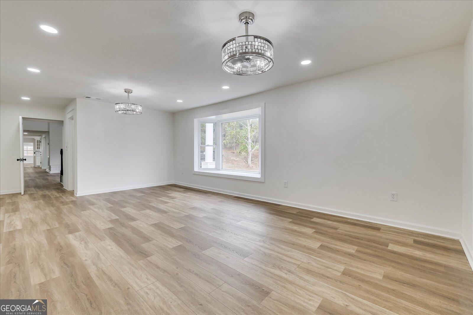 4756 Mike Padgett Highway Augusta, GA 30906 - Photo 6 of 28 a view of an empty room with a window and wooden floor