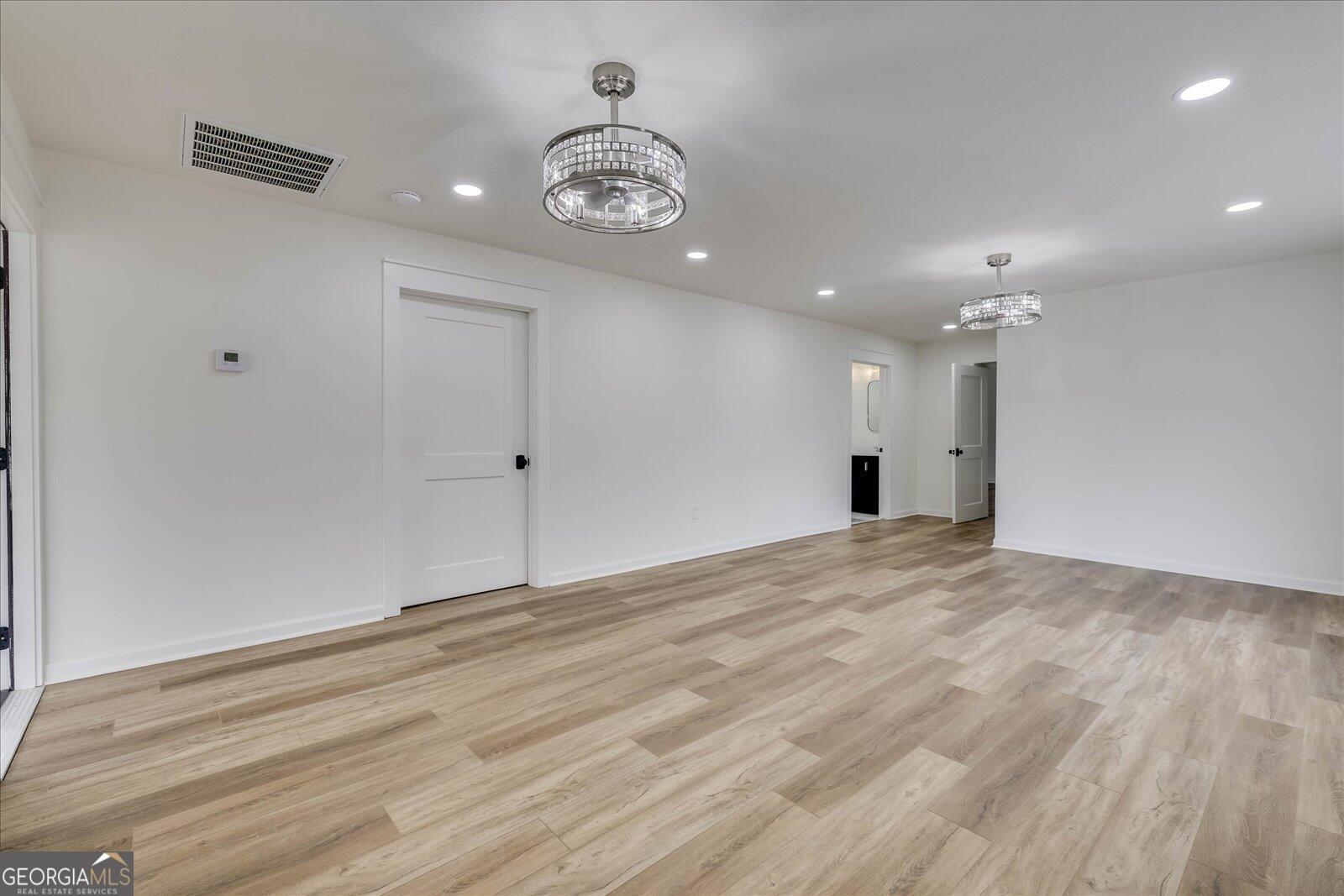 4756 Mike Padgett Highway Augusta, GA 30906 - Photo 7 of 28 a view of an empty room with wooden floor and a ceiling fan