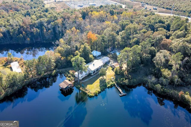 an aerial view of a house with yard swimming pool and outdoor seating