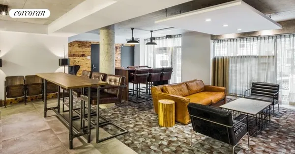 a outdoor kitchen with stainless steel appliances kitchen island granite countertop a table and chairs in it